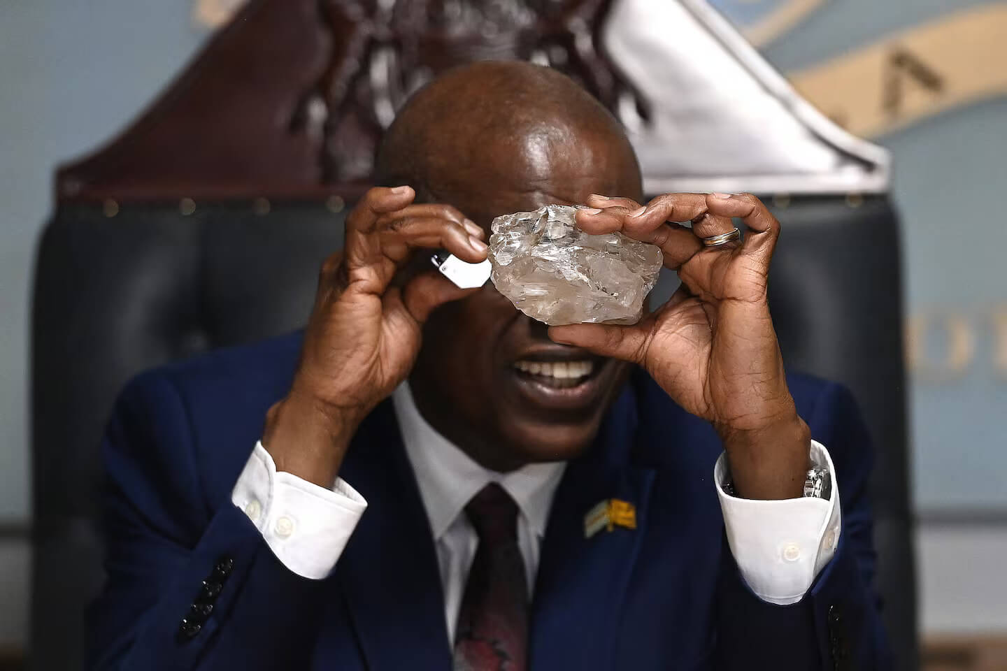 Former Botswana President Mokgweetsi Masisi marvels at a large, raw uncut diamond, the same gem featured in Drake's 'Iceman' album teaser, symbolizing African luxury and ethical sourcing.