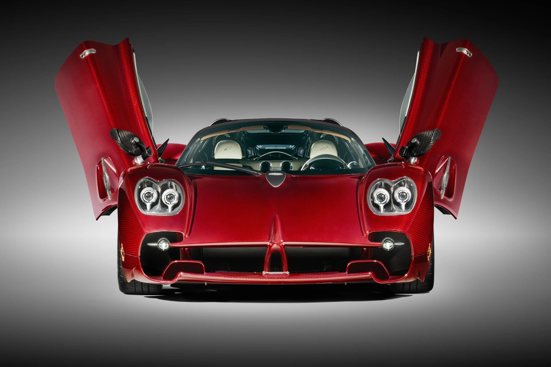 Front view of the Pagani Utopia Roadster with its signature dihedral butterfly doors open.