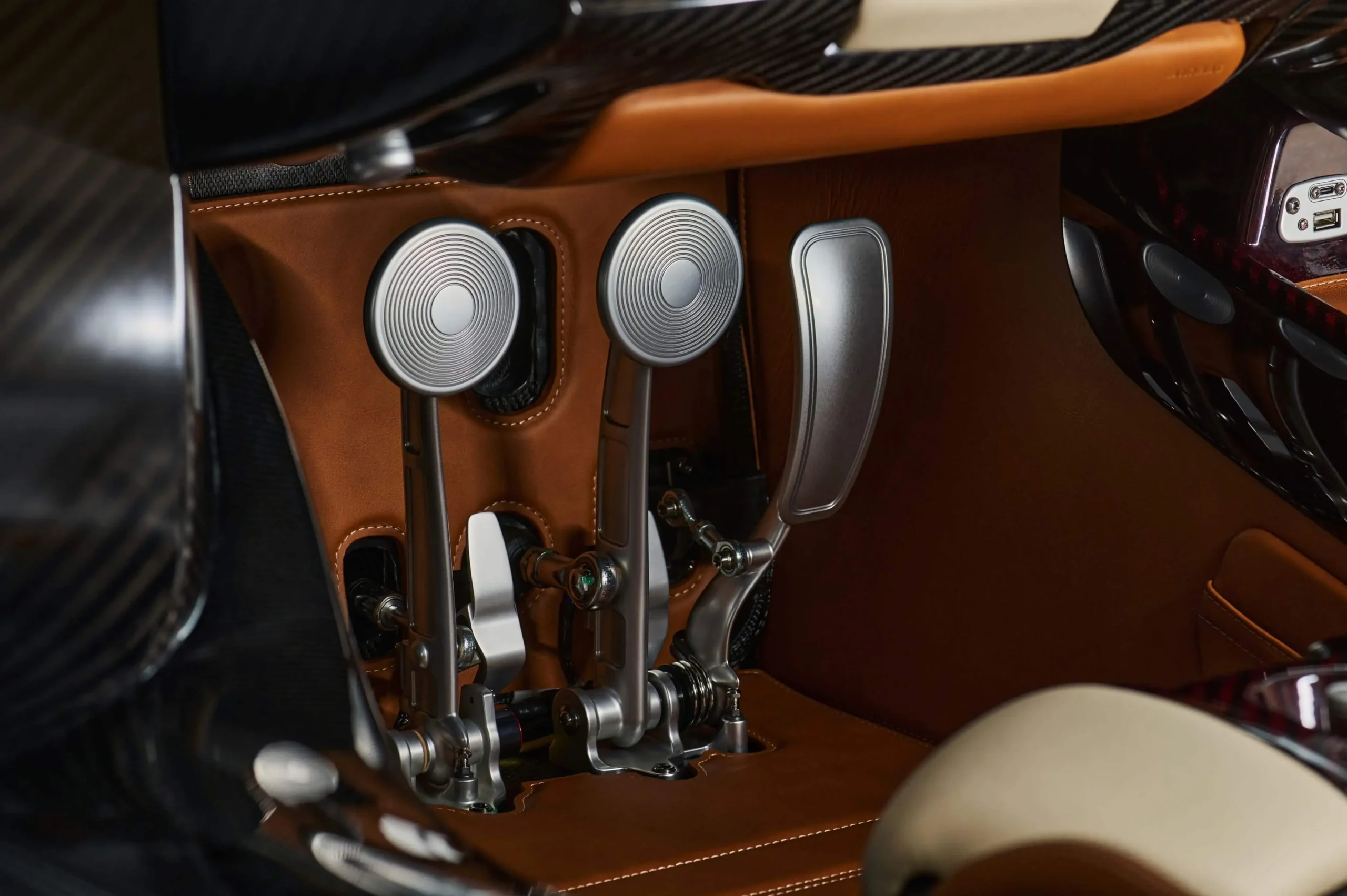 The custom-machined aluminum pedals of the Pagani Utopia Roadster in the driver footwell.